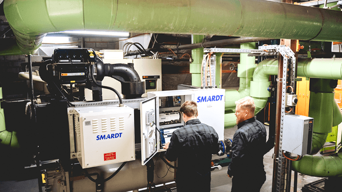two tradies working on large SMARDT HVAC system