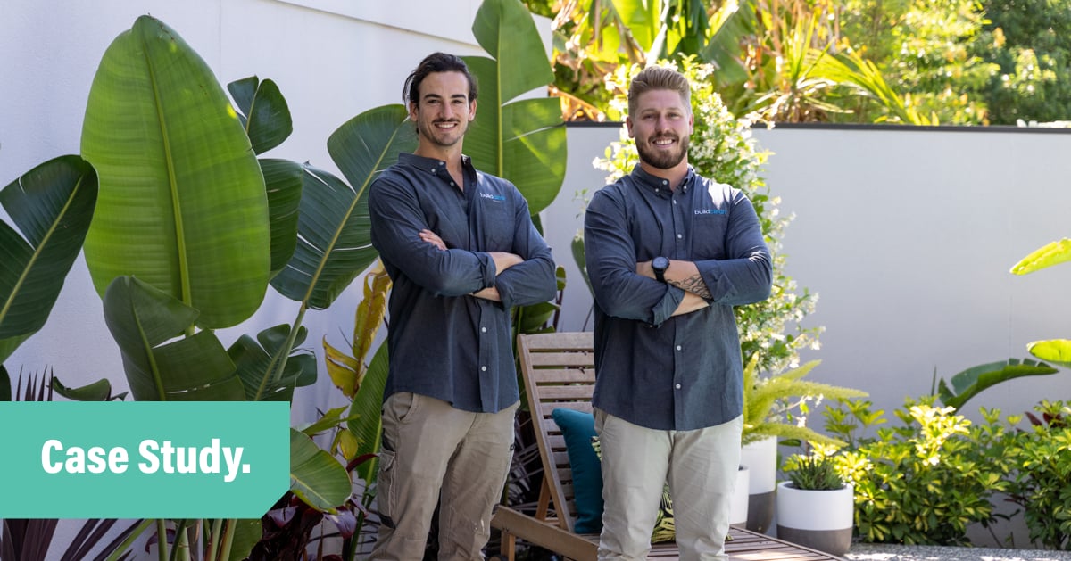 Customer story blog header featuring a photo of two men from the Build Clean team