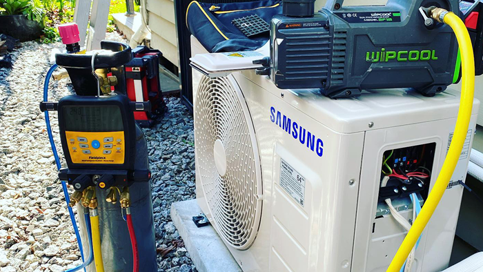 Samsung heat-pump unit surrounded by wipcool vacuum pump and other tools 