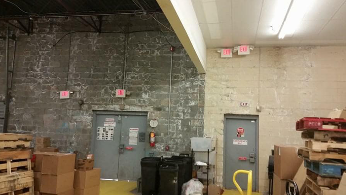 basement of building with fire exit signage over doors