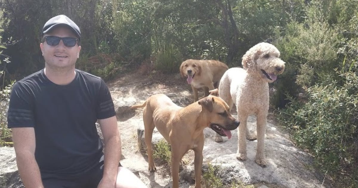 Adam out for a walk with his 3 dogs