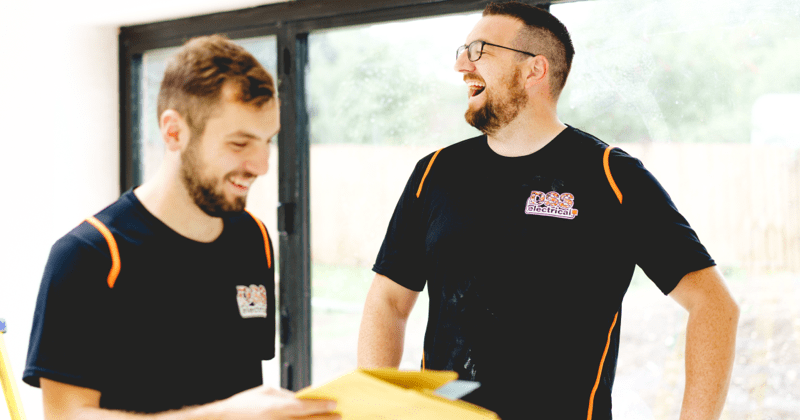 dan from dss electrical laughing with his apprentice-min