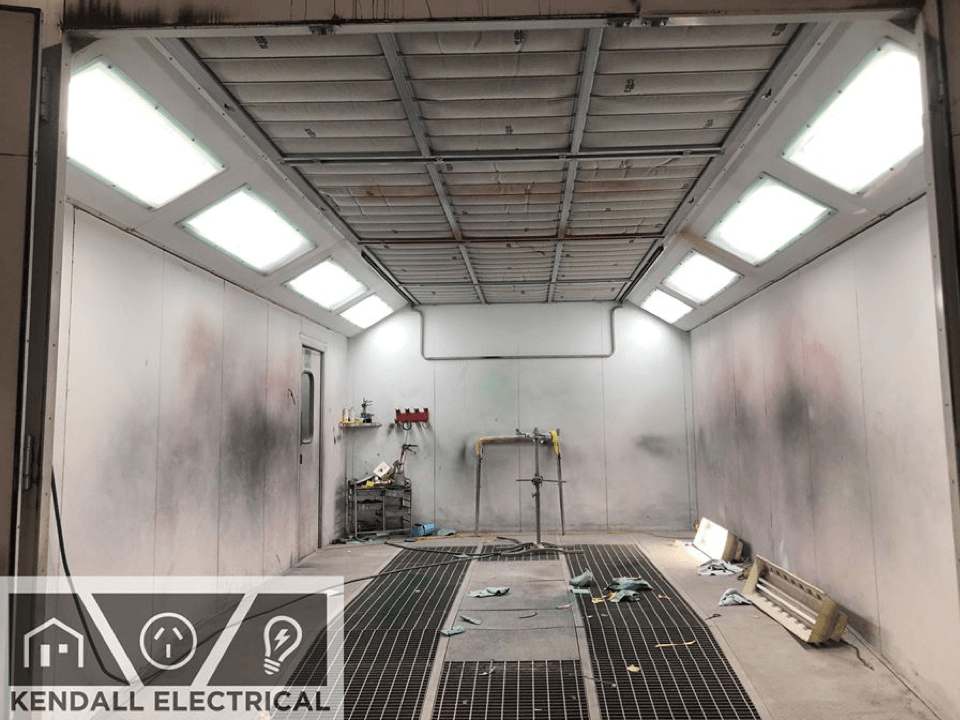 Kendall Electrical working on a job inside an automotive spray booth