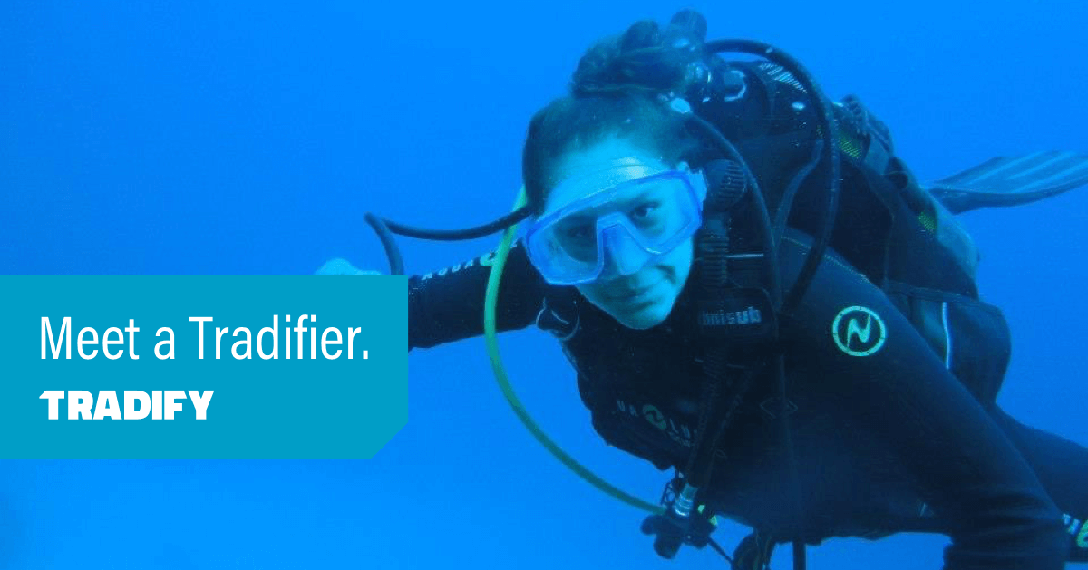Meet a Tradifier heading laid over a photo of Julie deep sea diving