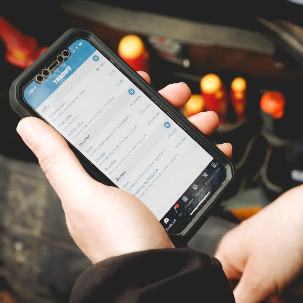 Features Image - Mobile - NZ - Tradesperson Holding Mobile Phone